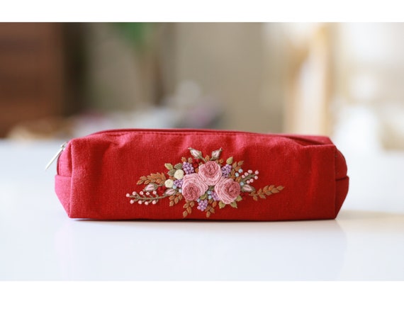 Embroidered makeup pouch deals
