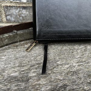 Gold zipper with cross and black satin ribbon marker