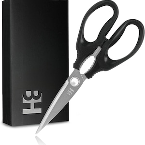 May include: Black kitchen shears with a silver blade and a black handle. The shears have a serrated edge and a spring-loaded mechanism. The shears are packaged in a black box with the letter "B" and "H" printed on the front.
