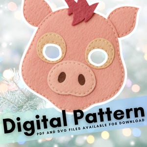 May include: A pink felt pig mask with tan eye surrounds and a red crest. The mask has stitched details and eye holes. Text at the bottom reads "Digital Pattern" with "PDF and SVG files available for download".