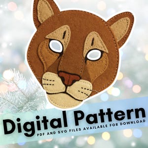 May include: A felt cougar mask in shades of brown, tan, and white, with stitched details. The mask has a cougar face design with white eye cutouts. Text at the bottom reads "Digital Pattern".