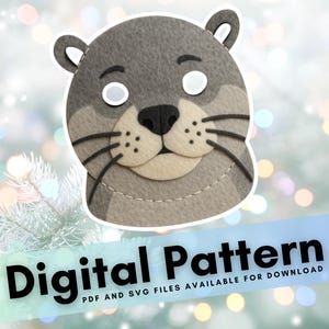 May include: A gray felt otter mask with white eye cutouts, black whiskers, and a beige nose. The mask has small, rounded ears and is stitched around the edges. Text at the bottom reads "Digital Pattern".