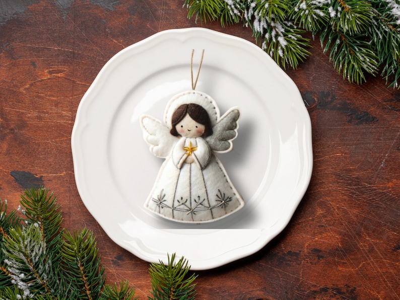 May include: White felt angel ornament with a gold star, on a white plate, against a brown wooden background.