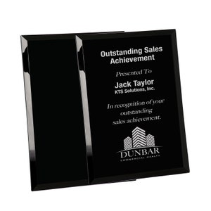 May include: Black glass plaque with silver engraved text. The text reads "Outstanding Sales Achievement", "Presented To Jack Taylor", "KTS Solutions, Inc.", "In recognition of your outstanding sales achievement." and "DUNBAR COMMERCIAL REALTY".