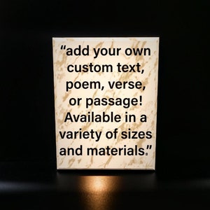 May include: A rectangular, off-white sign with a marbled texture. The sign features the text: "add your own custom text, poem, verse, or passage! Available in a variety of sizes and materials."