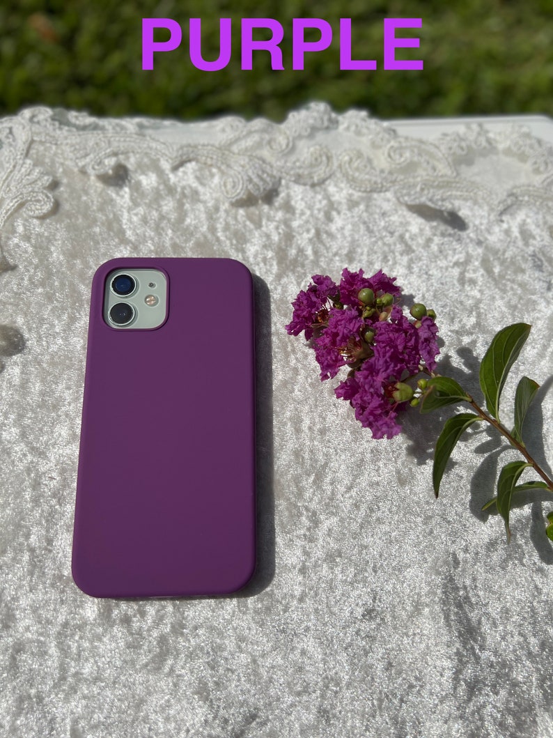 May include: Purple silicone phone case for an iPhone. The case is a solid color with no design.