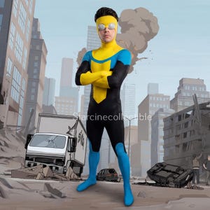 May include: A superhero costume in yellow and blue, worn by a person in a city setting. The costume has a yellow mask, chest design, and arm sections, with blue on the shoulders and legs. The background shows a city in a state of destruction.