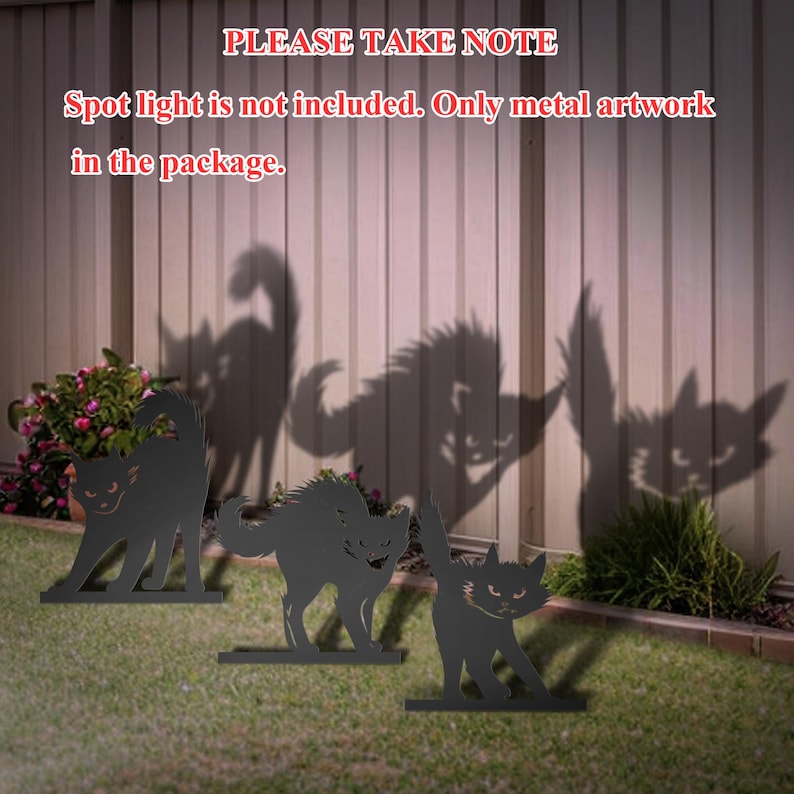May include: Three black metal cat silhouettes, standing on a grassy lawn in front of a wooden fence. The silhouettes are facing different directions and have a menacing look. The text "PLEASE TAKE NOTE Spot light is not included. Only metal artwork in the package." is displayed above the silhouettes.