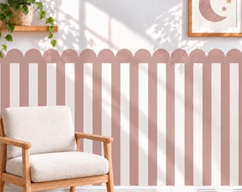 May include: Wall decal featuring vertical stripes in dusty rose and white, finished with a scalloped top edge. The design is applied to a wall, creating a decorative border effect that spans the width of the wall surface in a repeating pattern.