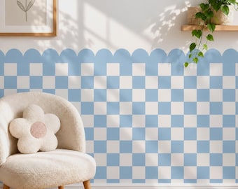 May include: A light blue and white checkered wall decal featuring a scalloped top edge. The pattern consists of repeating square blocks in a grid layout, applied to a smooth wall surface behind a cream-colored chair with a flower-shaped pillow.