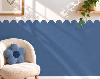 May include: A blue scalloped wall decal applied to a white wall, featuring a repeating rounded edge pattern. The decal covers the lower portion of the wall, creating a distinct horizontal border that contrasts with the plain white upper section.
