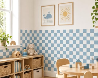 May include: A room featuring light blue and white checkered wallpaper covering the lower half of the wall. The space includes a light wood cubby shelf with woven baskets, a round wooden table with wooden blocks, and two framed wall prints.