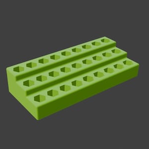 May include: A lime green, stepped organizer with multiple hexagonal holes. The organizer has three levels, each with a row of evenly spaced holes. The object is made of a solid material and sits against a dark gray background.