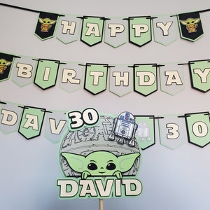 May include: Green and white banner with the words "Happy Birthday David 30" and images of a cartoon character. The banner is decorated with black and white images of a cartoon character.