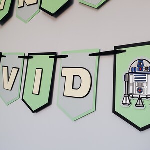 May include: Green and grey banner with the name "DAVID" and a cartoon image of R2-D2 from Star Wars.