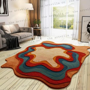 Puede incluir: Una alfombra de área abstracta y colorida con un diseño en capas. La alfombra presenta una forma beige central rodeada de bandas rojas, naranjas, verde azulado y marrones. La alfombra está colocada sobre un suelo de madera clara.