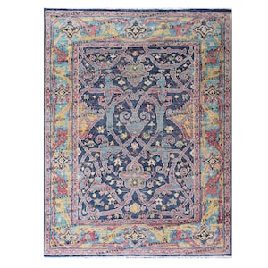 May include: A blue, red, and yellow patterned rug with a floral design. The rug has a border with a repeating pattern of stars and diamonds.
