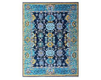 May include: A blue rug with a floral pattern in shades of yellow, blue, and white. The rug has a border with a repeating pattern.