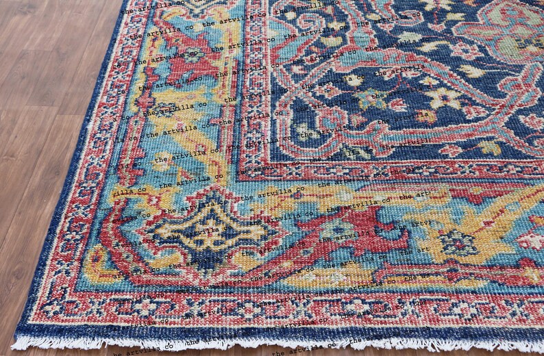 May include: A blue, red, and yellow patterned rug with a fringed edge. The rug has a traditional Persian design with intricate details.