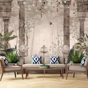 May include: A living room setting with a beige sofa, wooden armchairs, and a coffee table. The backdrop is a mural depicting classical columns, greenery, peacocks, and floral details. Decorative cushions provide colour.