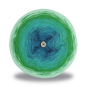 May include: A round ball of yarn with a gradient of colors, transitioning from light green to teal and then to a deep blue. A small gold-colored heart-shaped charm is attached to the yarn. The yarn ball is set against a white background.