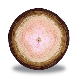 May include: A skein of yarn in a gradient of brown, beige, pink, and white colors. The yarn is wound into a circle and has a heart-shaped charm in the center.