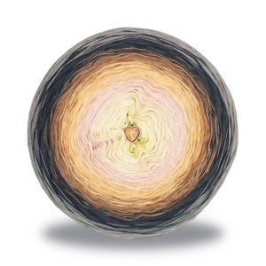 May include: A round ball of yarn with a gradient color scheme, transitioning from dark gray to light yellow, with shades of brown and pink in between. A small heart-shaped charm hangs in the center. Ideal for knitting and crochet projects.