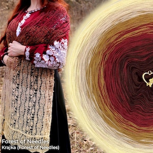 May include: A woman wearing a burgundy shawl with intricate crochet detailing and white floral embroidery on the sleeves. A large ball of yarn in shades of cream, gold, red, and brown is visible. A gold heart-shaped charm hangs from the yarn.