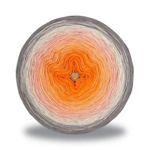 May include: A round ball of yarn with a gradient of colors, transitioning from gray to white, pink, orange, and back to orange in the center. A heart-shaped charm is attached to the center. Ideal for knitting and crochet projects.