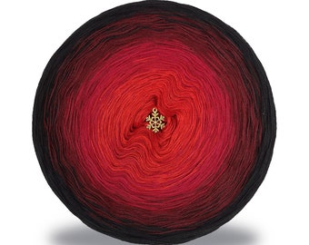 May include: A ball of red and black ombre yarn with a gold snowflake charm in the centre.