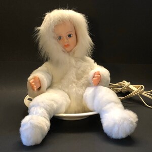 Vntg animated snow baby on sled