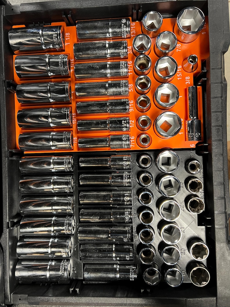 May include: A set of chrome sockets and extensions arranged in a black and orange storage case. The sockets are various sizes, including 1/2, 5/8, 3/4, and 7/8 inch. The case is organized with labeled slots for each tool, providing a clear view of the contents.