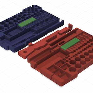 May include: Two plastic tool organizers, one navy blue and one red-orange, each with a green rectangular insert. The organizers have various sized circular and rectangular compartments. The design suggests a system for organizing small tools or components.