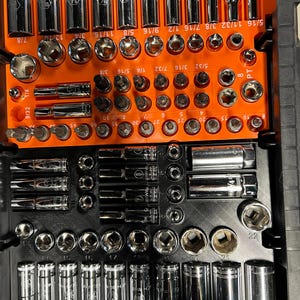 May include: A complete socket set organized in a black and orange case. The set includes various sizes of sockets, extensions, and bits. The sockets are chrome-plated and arranged in numerical order, with sizes ranging from 1/4 to 7/8 inches.
