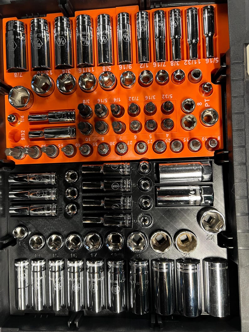 May include: A complete socket set organized in a black and orange case. The set includes various sizes of sockets, extensions, and bits. The sockets are chrome-plated and arranged in numerical order, with sizes ranging from 1/4 to 7/8 inches.
