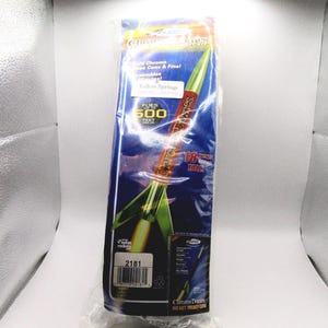 May include: A model rocket kit in clear plastic packaging featuring a Chrome Domes rocket with a metallic finish. The packaging displays text including "Flies up to 600 feet," "18 inches tall," and the product number 2181 on a blue background.