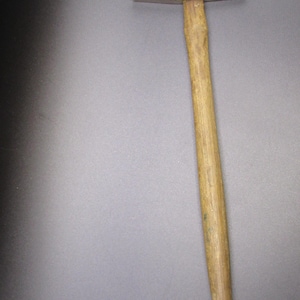 May include: A claw hammer with a wooden handle and a metal head. The hammer's head is rectangular with a flat striking face. The handle is a light brown color and tapers towards the end. The hammer is a tool used for construction and repair.