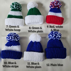 May include: Six knitted hats with pom-poms in various colors and patterns, including green, white, blue, and red. The hats are labeled with numbers 7 through 12 and descriptions of their colors and patterns.