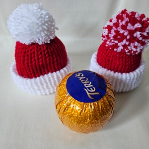 Santa hat chocolate orange covers - hand knitted