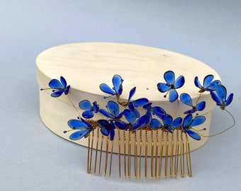 Golden hair comb with blue flowers