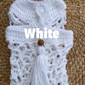 May include: White crocheted bag with a wooden bead and tassel. The bag has a lacy design and is perfect for carrying small items.