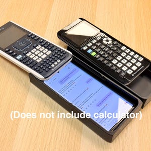 May include: Two scientific calculators, one black and one white, rest on a wooden surface. A smartphone with a blue screen is in a black tray. The text "(Does not include calculator)" is at the bottom of the image.