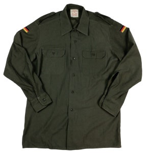 Vintage 1989 German military button front shirt. Measures as an L/XL. 22 inches pit to pit, 31 inches long. No rips, Tears or stains. Faded.