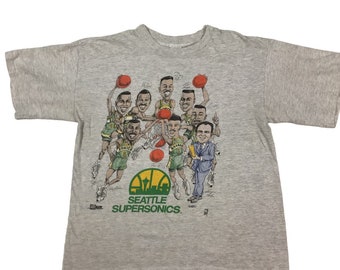 Vintage 90s Seattle Sonics caricatures NBA single stitch T-shirt. Made in the USA. Salem sportswear. Double sided graphic. Tagged as a large