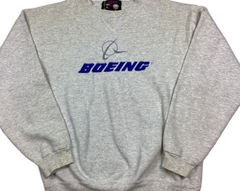 Vintage Boeing 90s Crewneck sweatshirt. Made in the USA. Stitched graphic. Tagged as a large. Grey and Blue