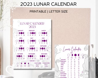May include: Printable 2023 lunar calendar with a purple and white colour scheme. The calendar shows the phases of the moon for each month, along with the dates of solar and lunar eclipses.