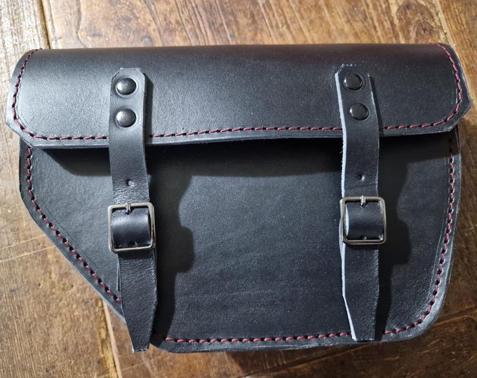 Moto Guzzi V7 right side bag. Black leather with red stitching.