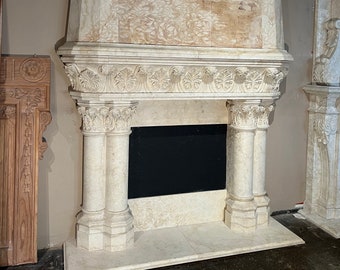May include: A white stone fireplace with a black firebox and a decorative stone surround. The surround features a carved design and a painted mural of a forest scene with a waterfall.