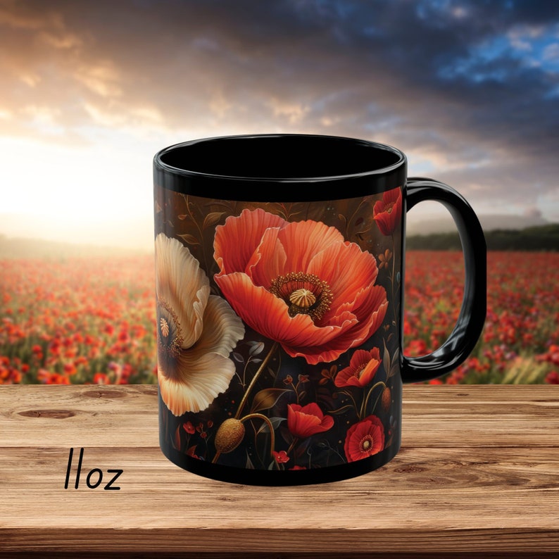 May include: Black ceramic mug with a floral design featuring red and white poppies on a dark background. The mug has a black handle and is 11 ounces.