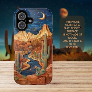 May include: A phone case with a desert landscape design. The case features a blue sky with stars and a crescent moon, a winding river, and tall cacti. The background is a rocky mountain range. The text "THIS PHONE CASE HAS A FLAT, SMOOTH SURFACE, IS NOT MADE OF WOOD, AND IT'S NOT A 3D OR TEXTURED." is printed on the case.